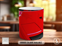 A red mug with a graphic design on it, placed on a wooden surface.