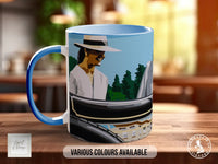 A blue and white mug with an illustration of a person wearing a hat and standing in front of a scenic landscape.