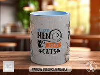 A ceramic mug with a cat design and text printed on it, placed on a wooden surface.