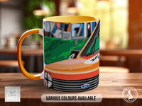 A colorful mug with an illustration of a car on it, placed on a wooden surface.
