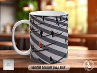 A white mug with a black and white striped pattern depicting a group of people walking on a sidewalk.