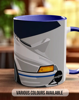 A mug with a graphic design of a car on it, placed on a wooden surface.