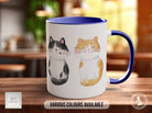 a coffee mug with a picture of two cats on it