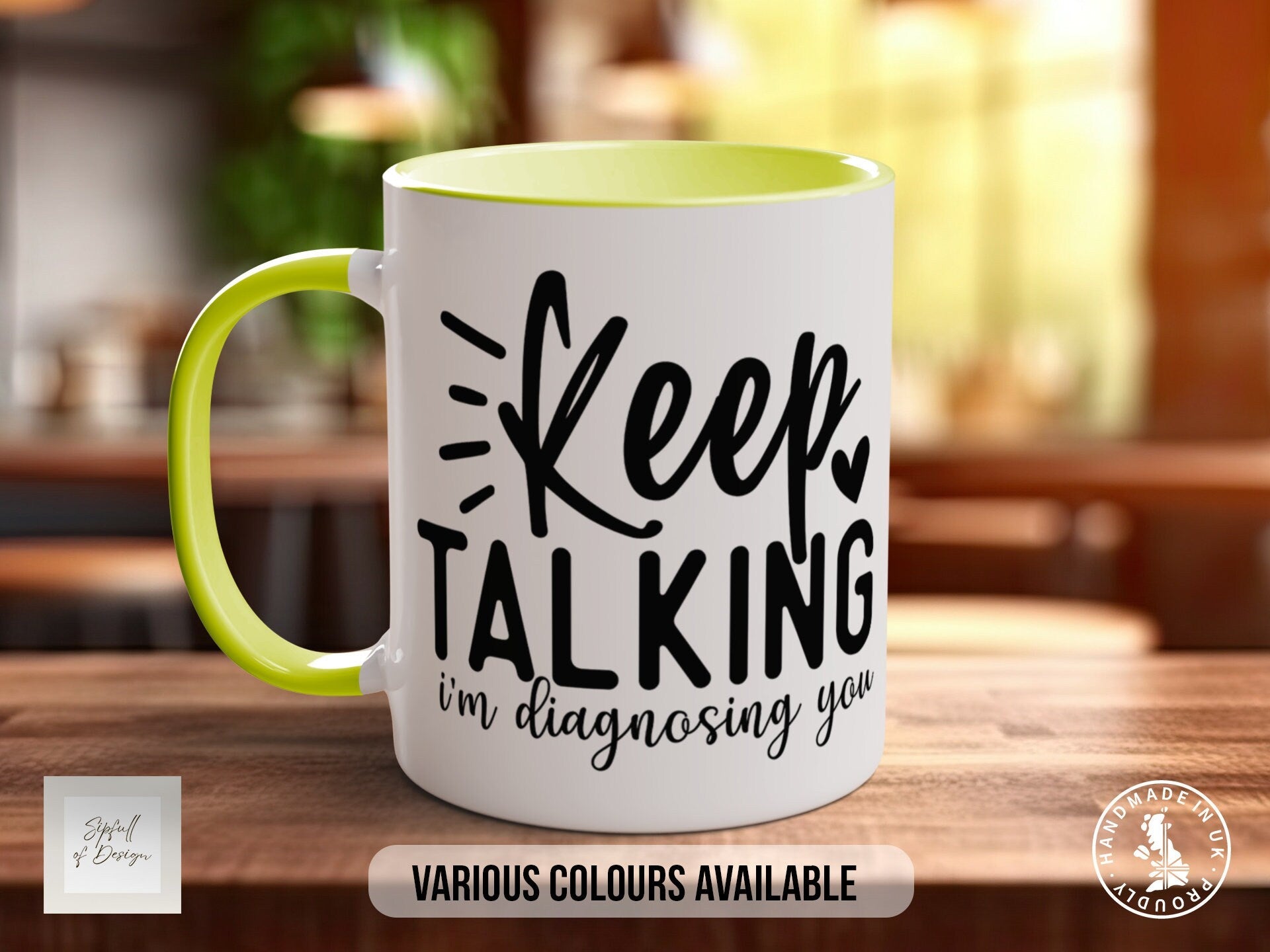 a yellow and white coffee mug sitting on top of a wooden table