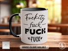 a white and black coffee mug sitting on top of a wooden table