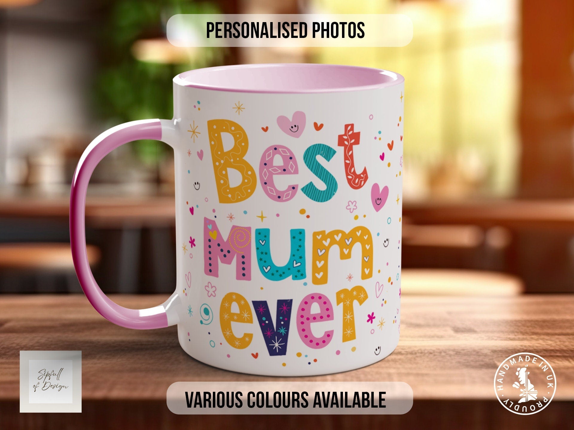 a pink and white coffee mug sitting on top of a wooden table