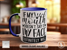 a blue and white coffee mug sitting on top of a wooden table
