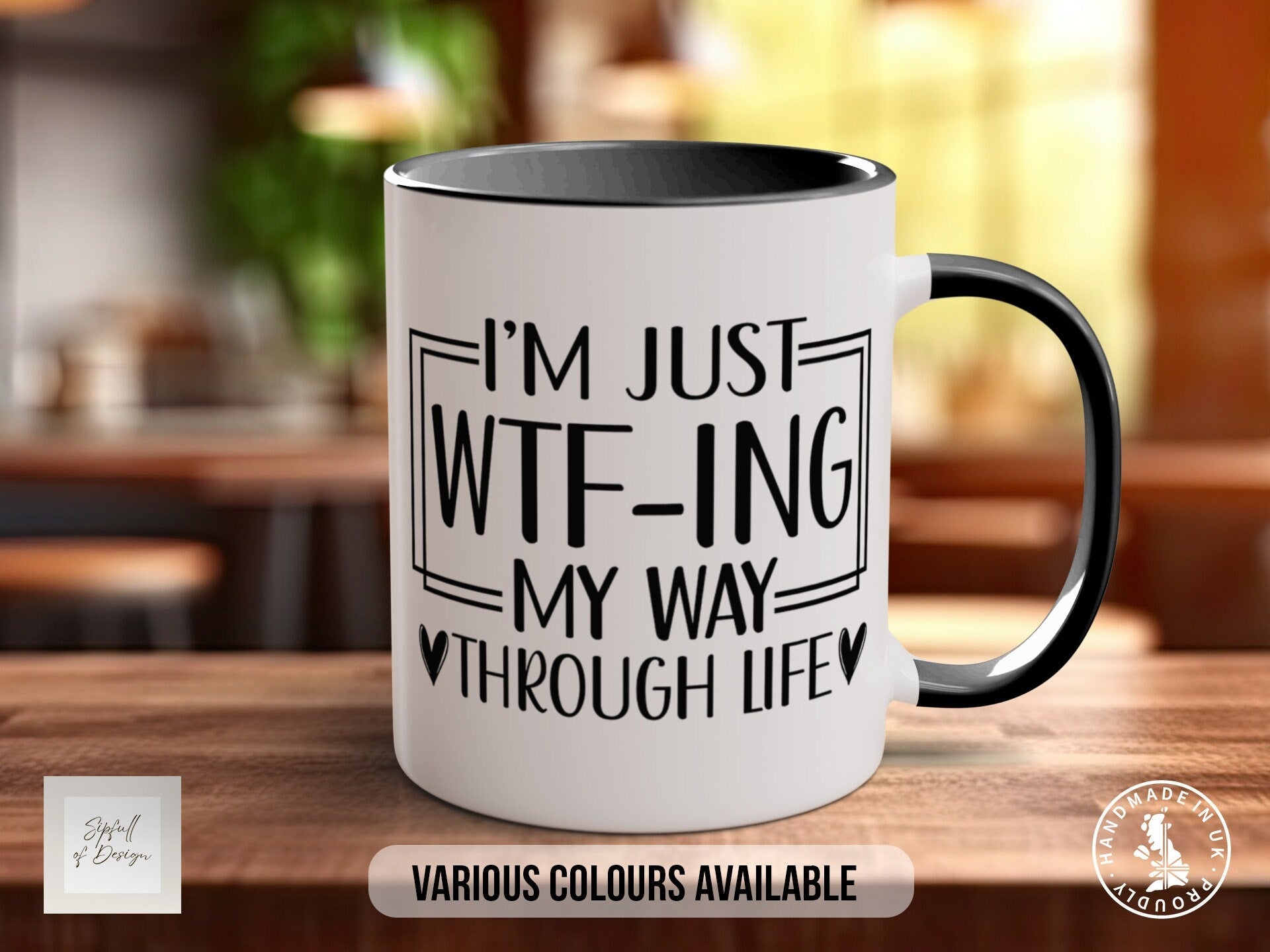 a white and black coffee mug sitting on top of a wooden table