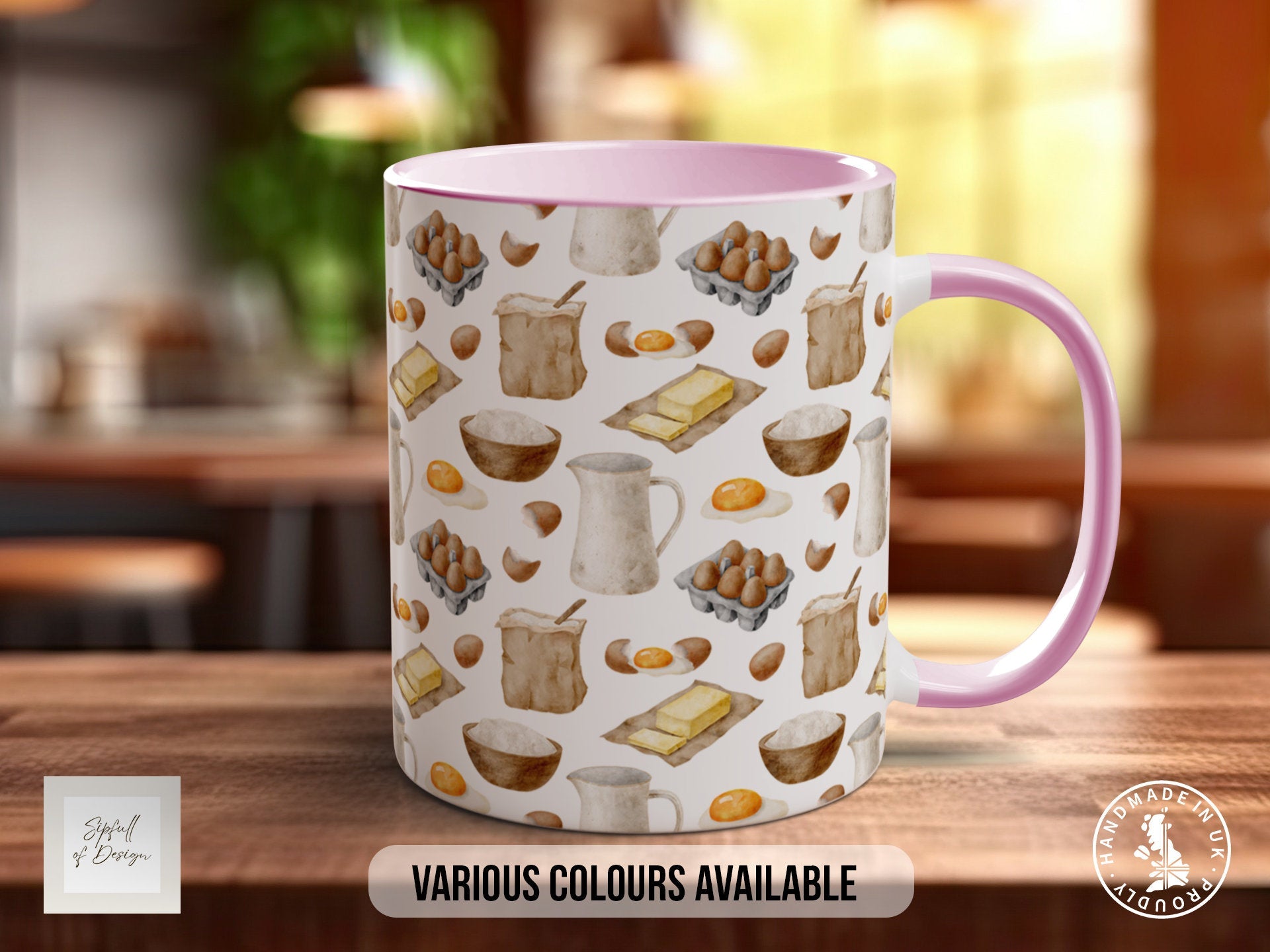 a pink and white coffee mug sitting on top of a wooden table