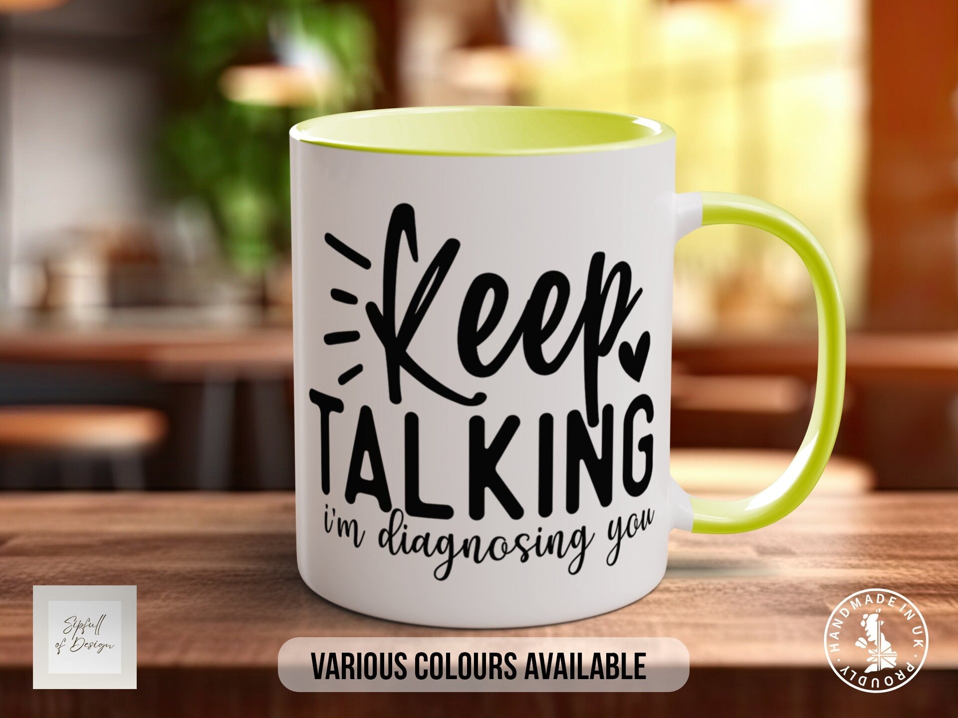 a green and white coffee mug sitting on top of a wooden table
