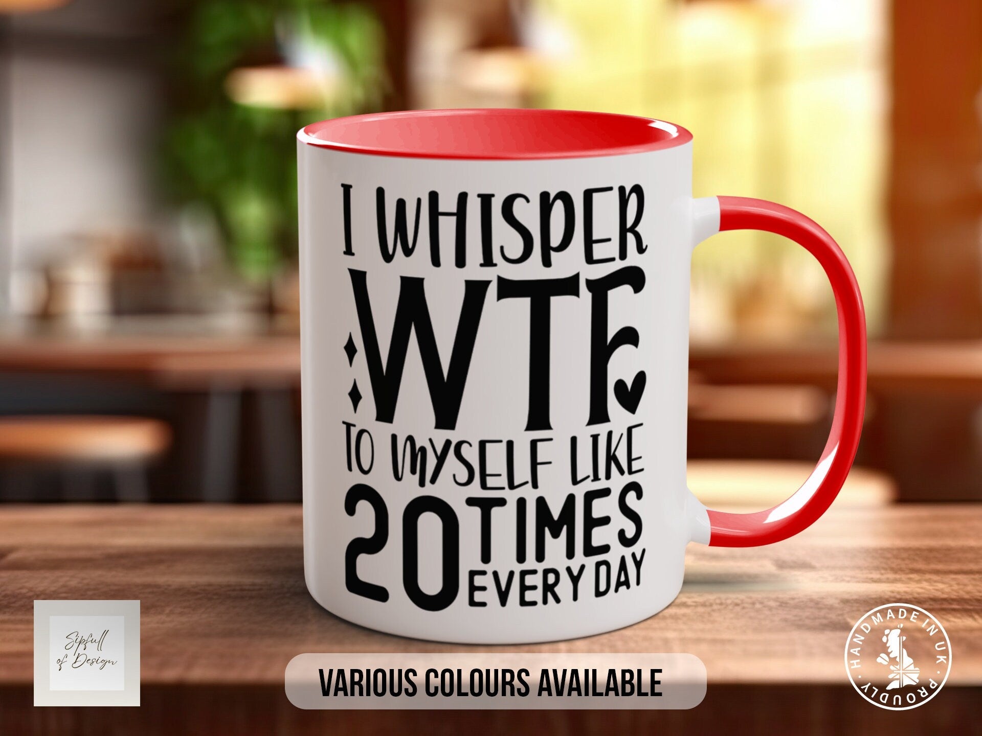 a red and white coffee mug sitting on top of a wooden table