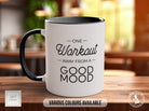 a white and black coffee mug sitting on top of a wooden table