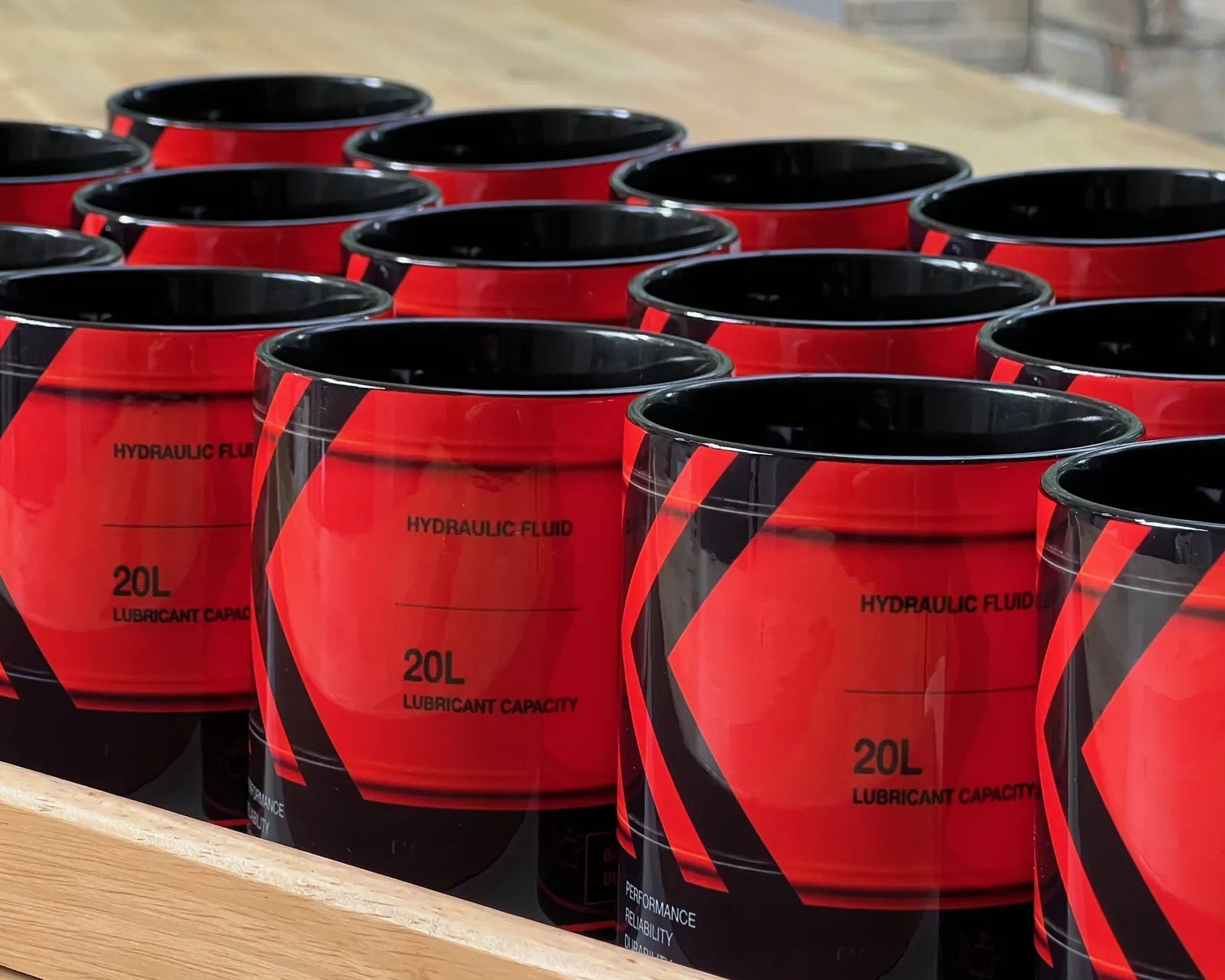 Rows of bespoke Kubota-branded mugs, handpressed by Sipfull of Design commissioned mugs — Sipfull of Design